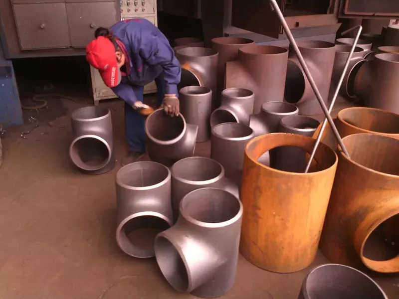 Manual inspection of copper nickel tee dimensions and surface quality before shipment